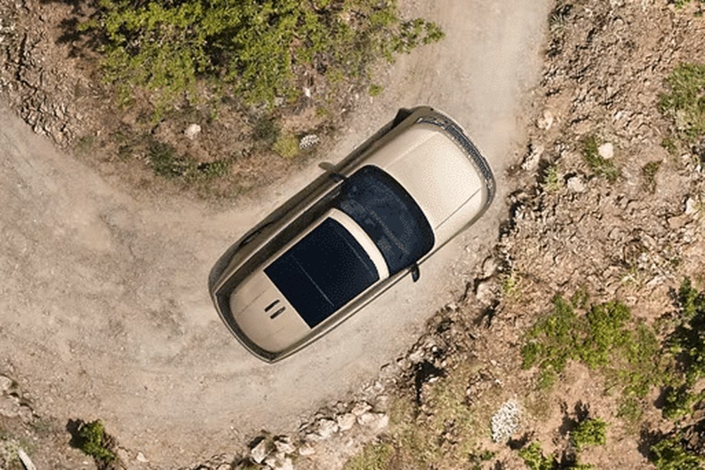 2026 Land Rover Range Rover overhead view of beige suv on a dirt road curve