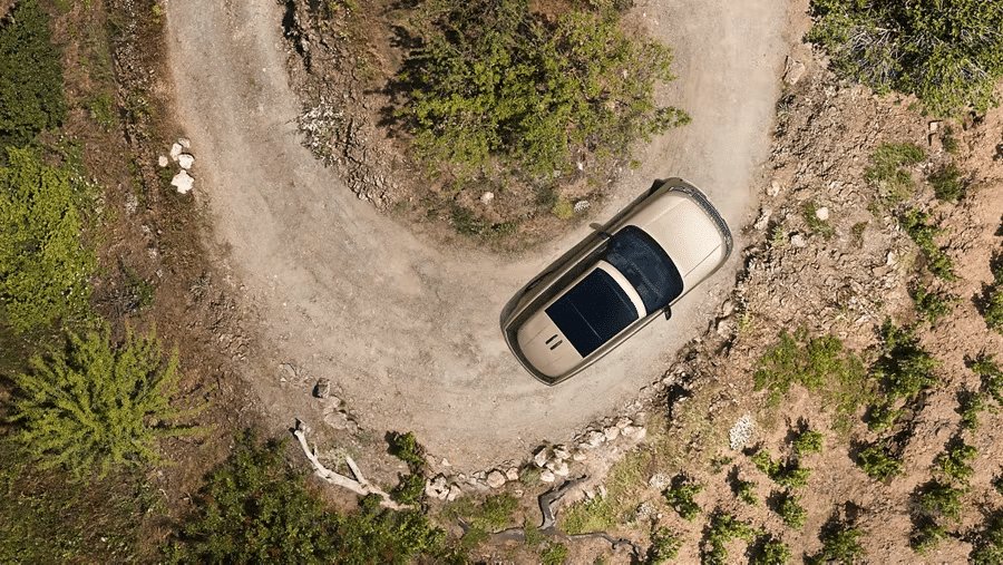 2026 Land Rover Range Rover overhead view of an suv turning on a dirt road