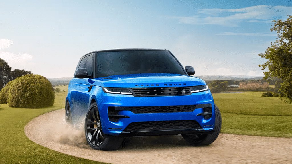 2026 Land Rover Range Rover Sport front view driving on a gravel road through a park