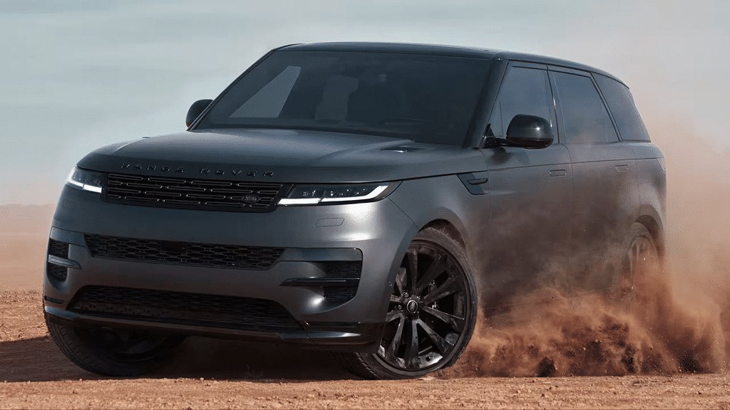 2026 Land Rover Range Rover Sport front three-quarter view kicking up dust on a desert track