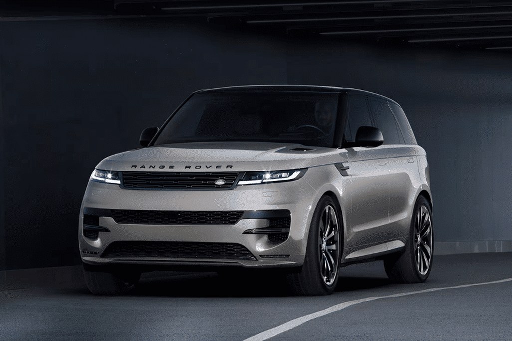 2026 Land Rover Range Rover Sport front three-quarter view parked in a dim concrete garage